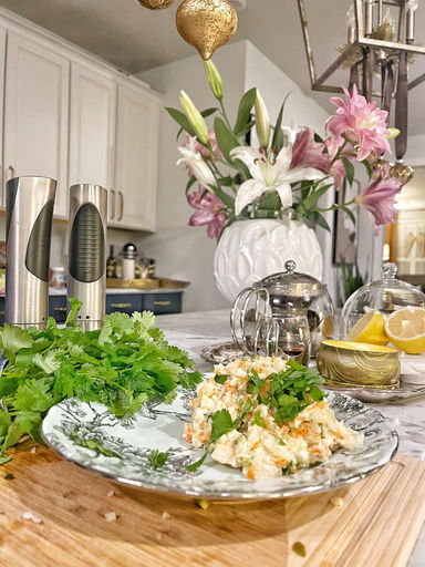 Kitchen island styled with fresh flowers, herbs and lemons — Cosmopolitan Interiors