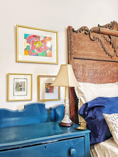 Personalized bedroom with gallery wall and antique headboard — Cosmopolitan Interiors