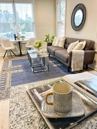 Occupied home staging — living room transformation with gray sofa and styled accessories
