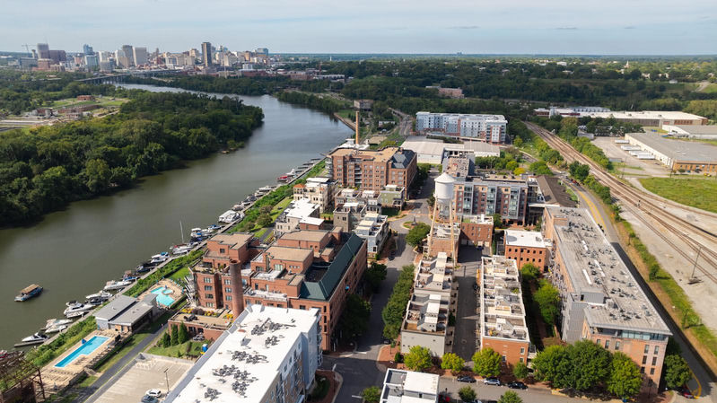 Aerial view of Richmond Virginia cityscape along the James River — home to Cosmopolitan Interiors