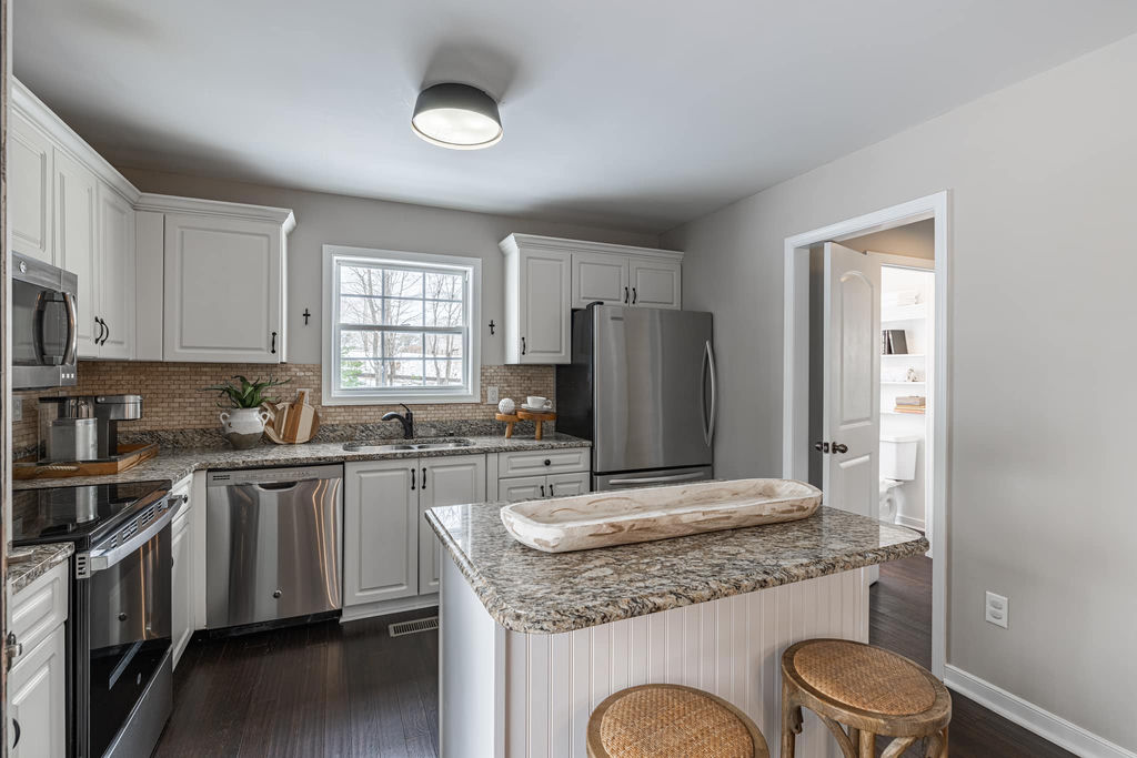 Staged kitchen with white cabinets and granite countertops — Richmond real estate staging